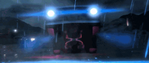 a car with a license plate that says ' x ' on it is driving down a road at night