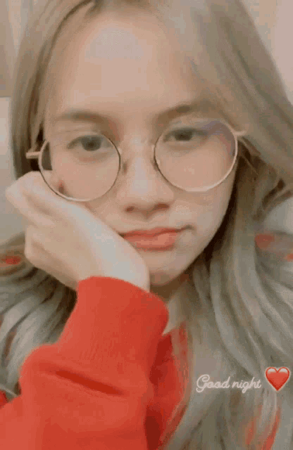 a girl wearing glasses and a red sweater says good night on the bottom