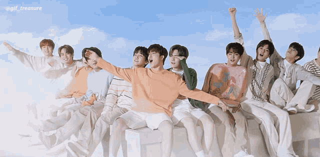 a group of young men are sitting in a row with their arms in the air and the words @gif_treasure above them