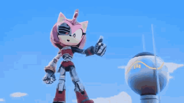 amy rose from the video game sonic the hedgehog is standing in front of a blue ball .
