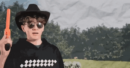a man wearing a cowboy hat and sunglasses is holding an orange toy gun