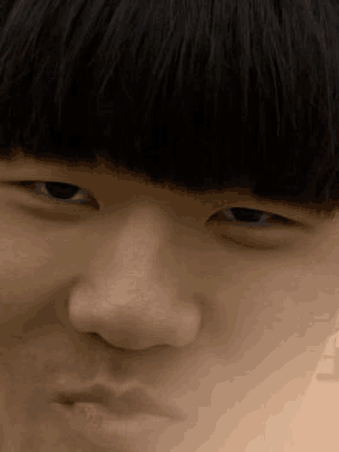 a close up of a young man 's face with a funny face .