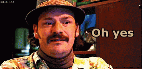 a man with a hat and a mustache says " oh yes "