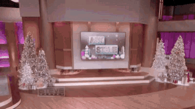 a large screen on a stage that says ask steve
