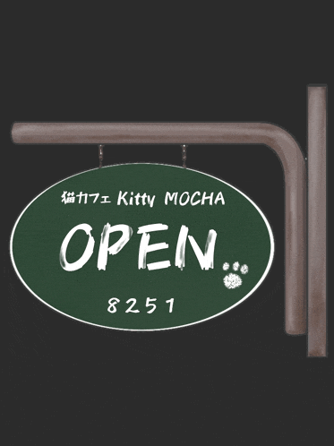 a green sign that says kitty mocha open on it