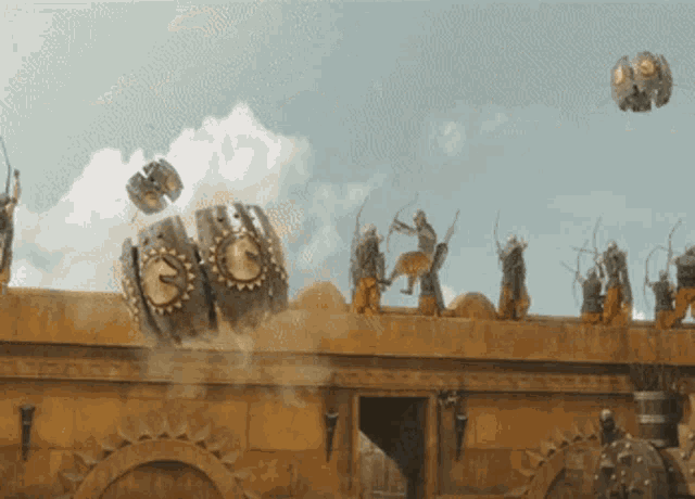 a group of soldiers are standing on top of a building with a clock on it that says ' g ' on it