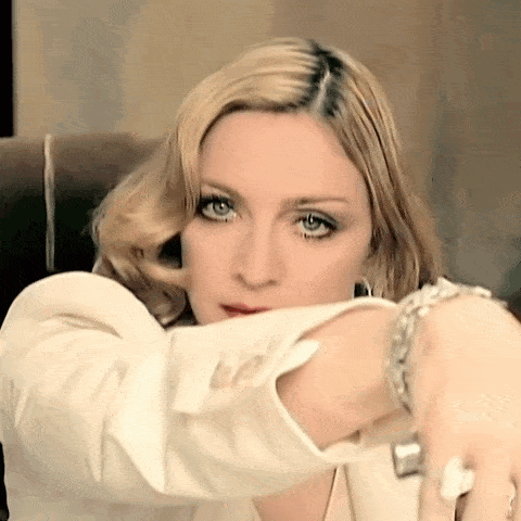 a woman wearing a white jacket and a silver bracelet