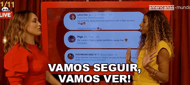 two women standing in front of a screen that says vamos seguir