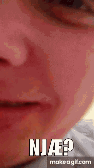 a close up of a person 's face with the words " njae " on it