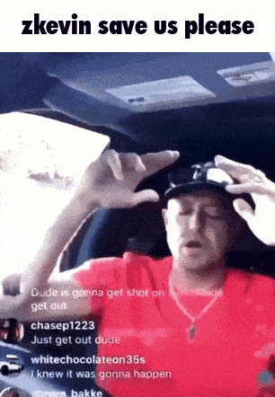 a man in a red shirt is sitting in a car and asking for help