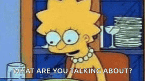 a cartoon character from the simpsons is sitting at a table with a plate of food .