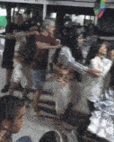 a group of people are gathered in a room and one of them is wearing a shirt that says ' a ' on it
