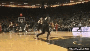 a basketball game is being played in a stadium with a crowd
