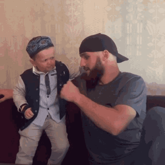 a man with a beard and a little boy wearing a hat