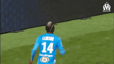 a soccer player in a blue jersey with the number 13 on it