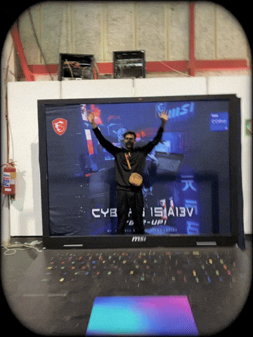 a man is standing in front of a large msi laptop