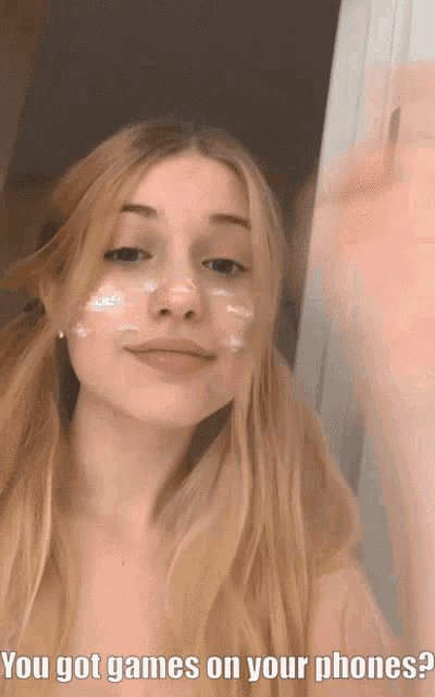 a girl with a white powder on her face is asking if she has games on her phones