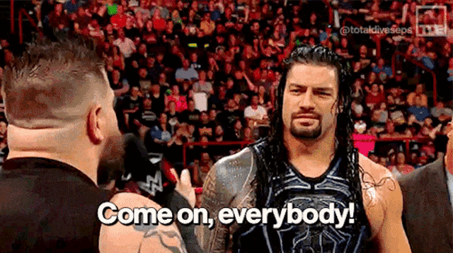roman reigns is standing in front of a crowd and says come on everybody .