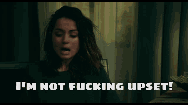 a woman is making a funny face with the words i 'm not fucking upset below her