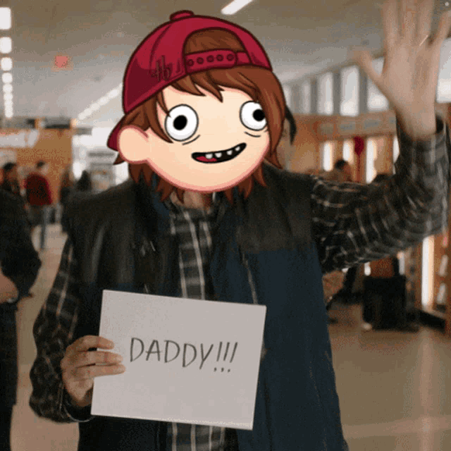a man holding a sign that says " daddy "