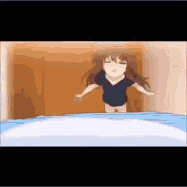 a girl in a black shirt is jumping out of a bed