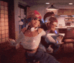 a blurry picture of a woman wearing headphones dancing in a room
