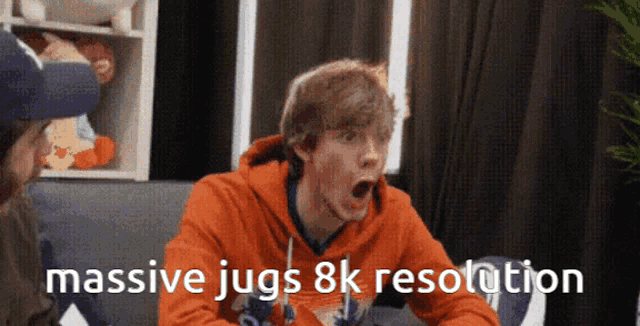 a man sitting on a couch with his mouth open and the words massive jugs 8k resolution