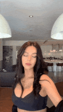 a woman in a black bra is taking a selfie