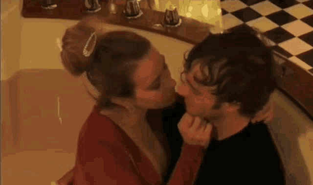 a man and woman are kissing in a bathtub