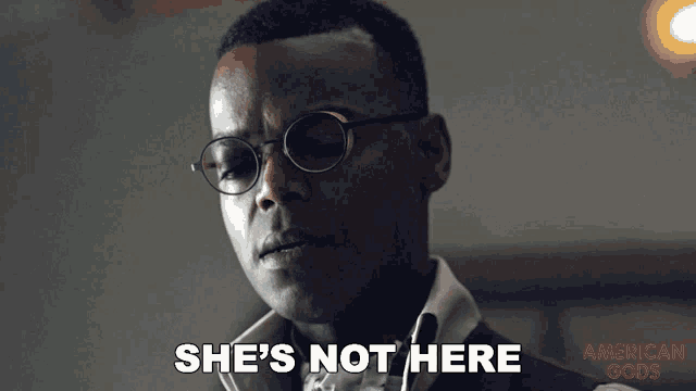a man wearing glasses says she 's not here on a screen