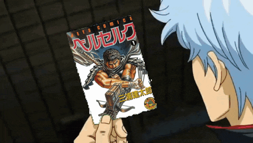 a man is holding a comic book that says berserk on it