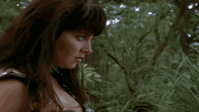 a man and a woman are standing in the grass