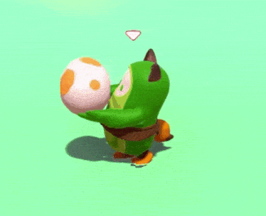 a green cartoon character is holding a pink and orange egg in his hands .