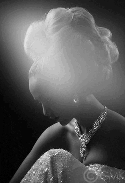 a black and white photo of a woman wearing a diamond necklace and earrings