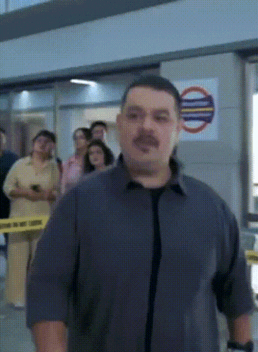 a man is standing in front of a sign that says " do not enter "