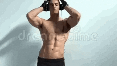 a shirtless man is listening to music with headphones on .