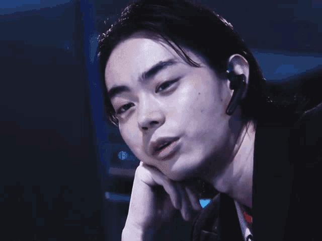 a close up of a man wearing a headset on his ear
