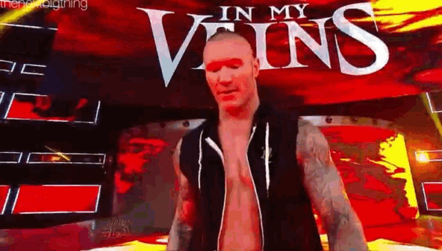 a man is standing in front of a sign that says in my veins .
