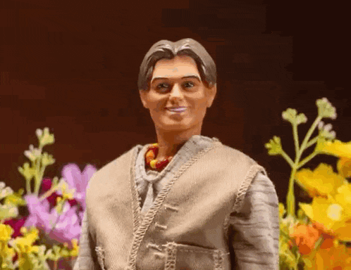 a barbie doll is standing in front of a bunch of flowers