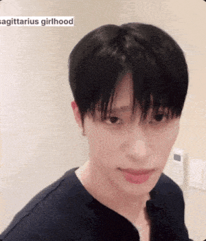 a close up of a person 's face with the words sagittarius girlhood on the bottom right