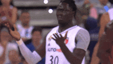 a basketball player wearing a white jersey with the number 30