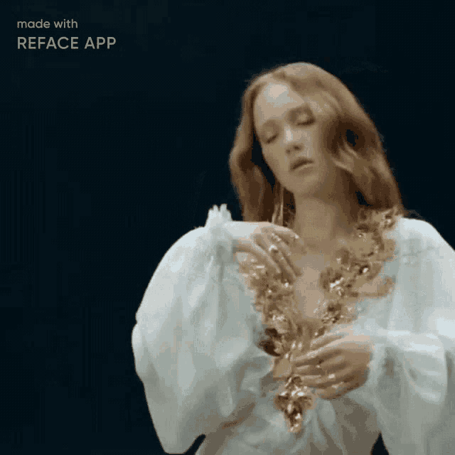 a woman with red hair is wearing a white dress and gold necklace