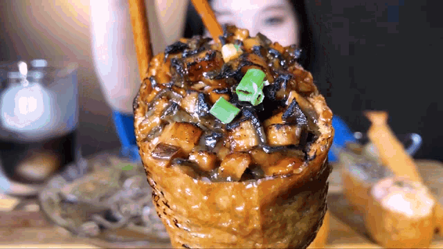 a close up of a person holding a very large container of food