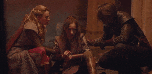 a man is kneeling down to help a woman who is sitting on the floor