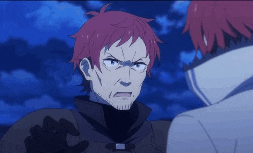 a man with red hair and a beard is looking at another man