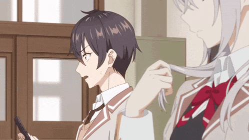a boy and a girl are standing next to each other and the girl is holding the boy 's hair