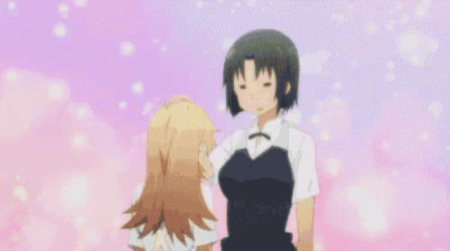 a blurry picture of a girl in a black dress standing next to another girl .
