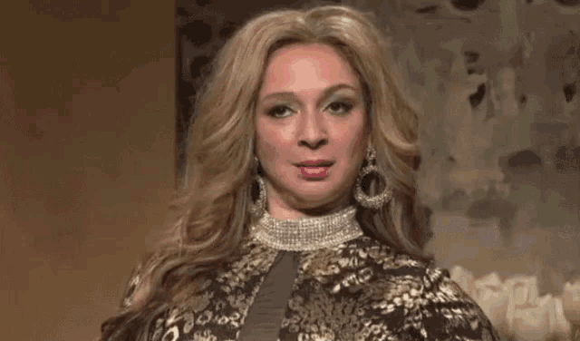 a woman with long blonde hair is wearing a wig and earrings .