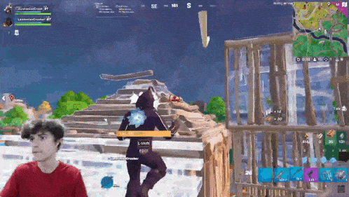 a man in a red shirt is playing a video game with the word edit on the screen