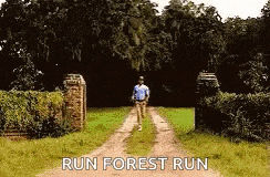 a man is running down a dirt road with the words run forest run on the bottom .